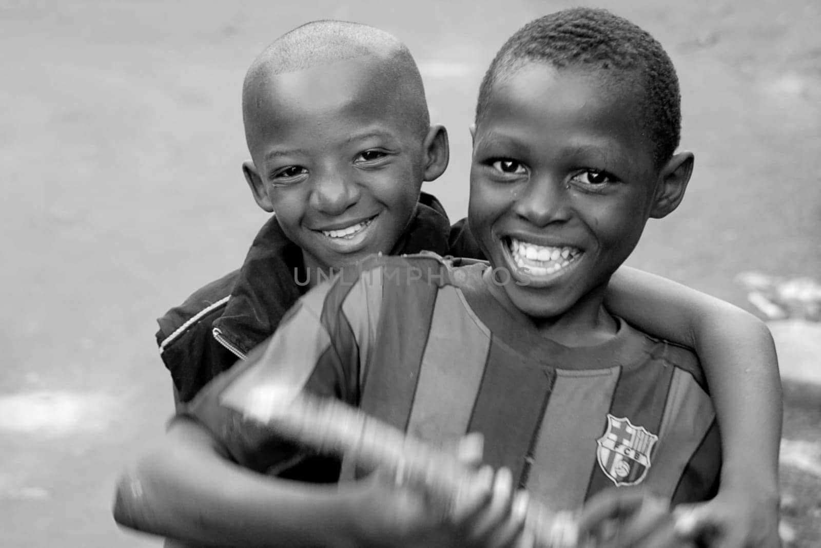 Two street children from Yaoundé,the capital of Cameroon,they live in a foyer of the Prebsbyteran Church which is also supported by us. The two lost their mothers because of AIDS,but they have retained their irrepressible zest for life. I want v
