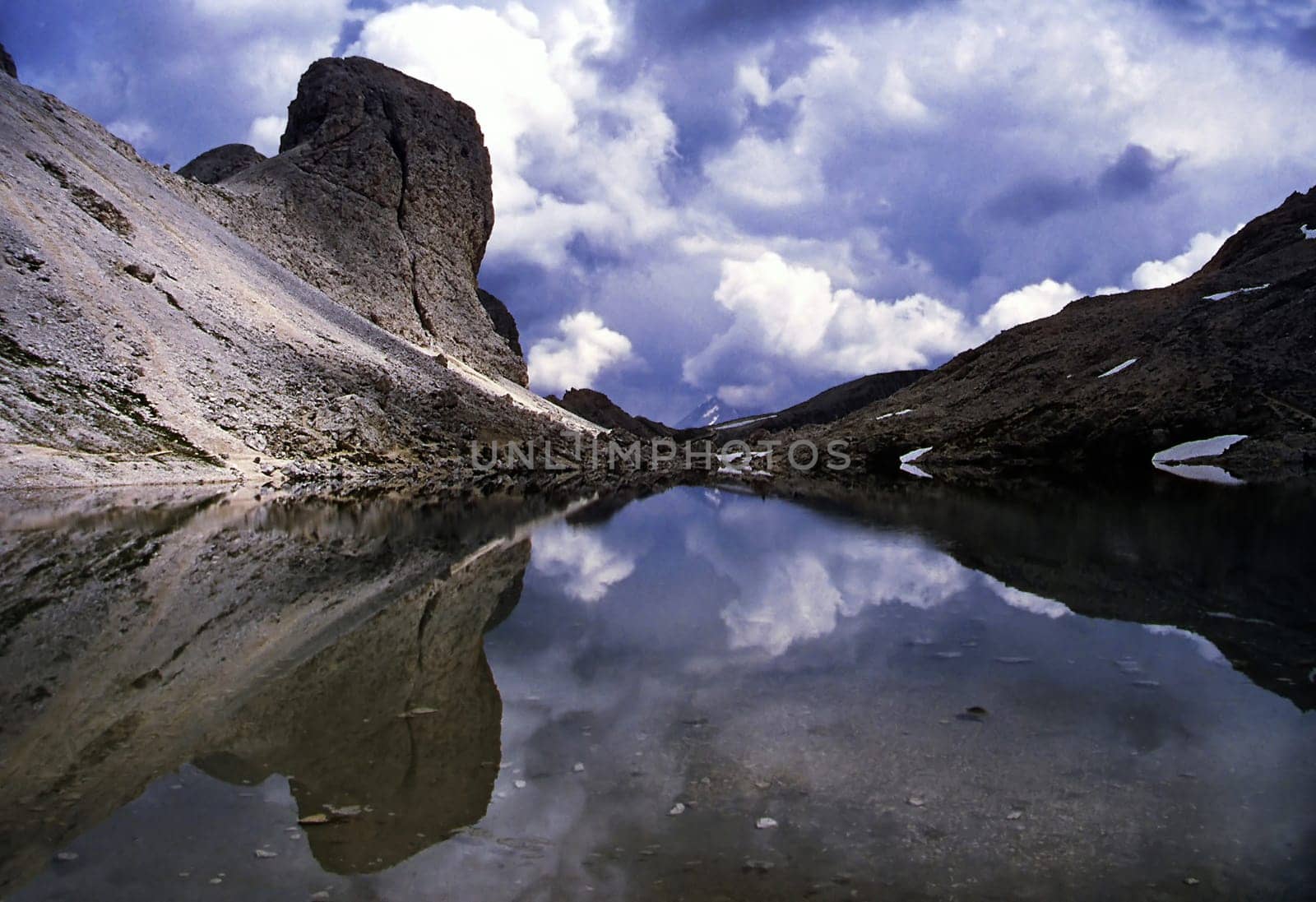 The beautifully situated Lago de Antermoia is located in the center of the Catinaccio Mountains/Dolomites/Italy. The approaching thunderstorm caused this almost eerie atmosphere. The picture was taken in 1994 with an Agfa Ultra 50 slide film.