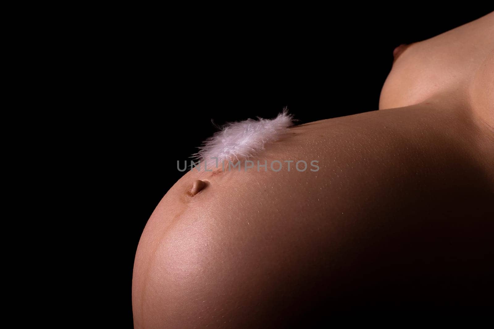Feather on baby bump
