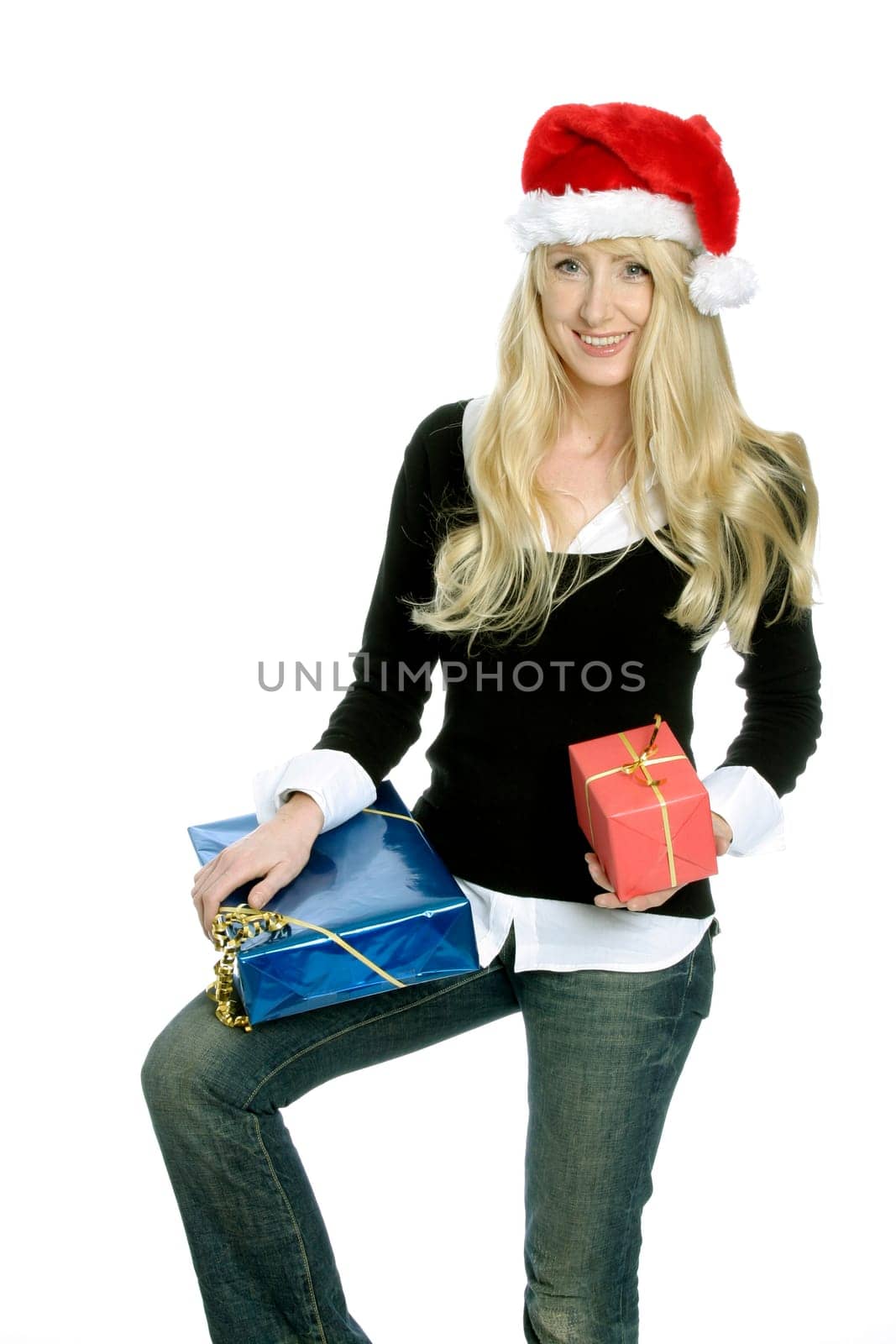Young woman with Santa Claus hat and gifts