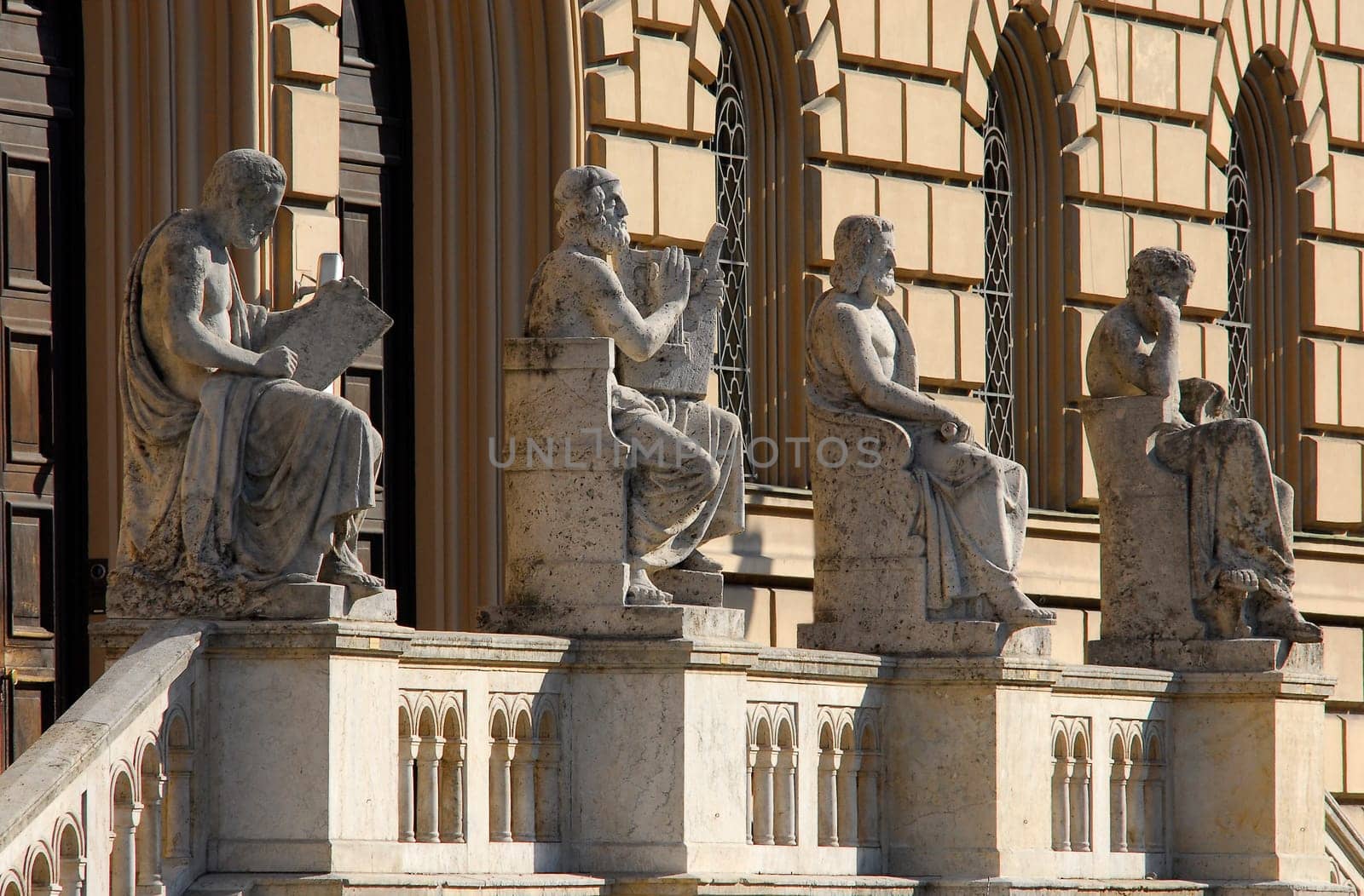 ... in front of the Munich State Library,from left to right: Thucydides (historiography),Homer (geang/poetry),Aristotle (political philosophy),Hippocrates (natural history/medicine)
