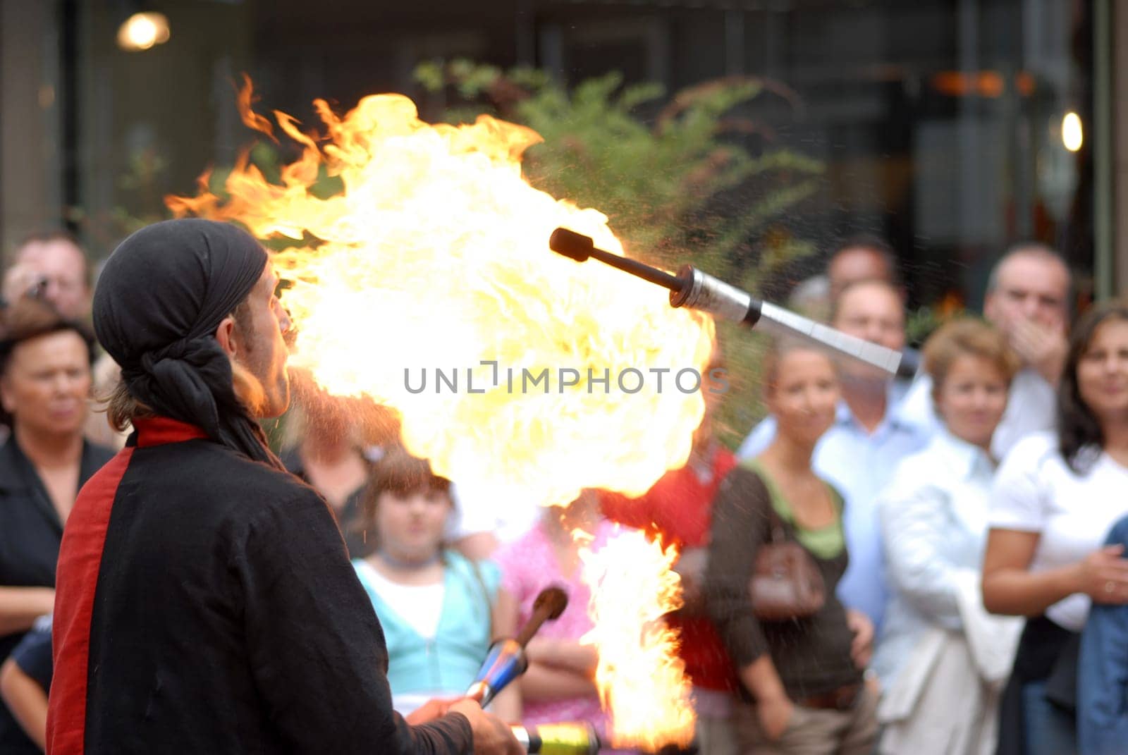 Fire-breathing juggler with audience