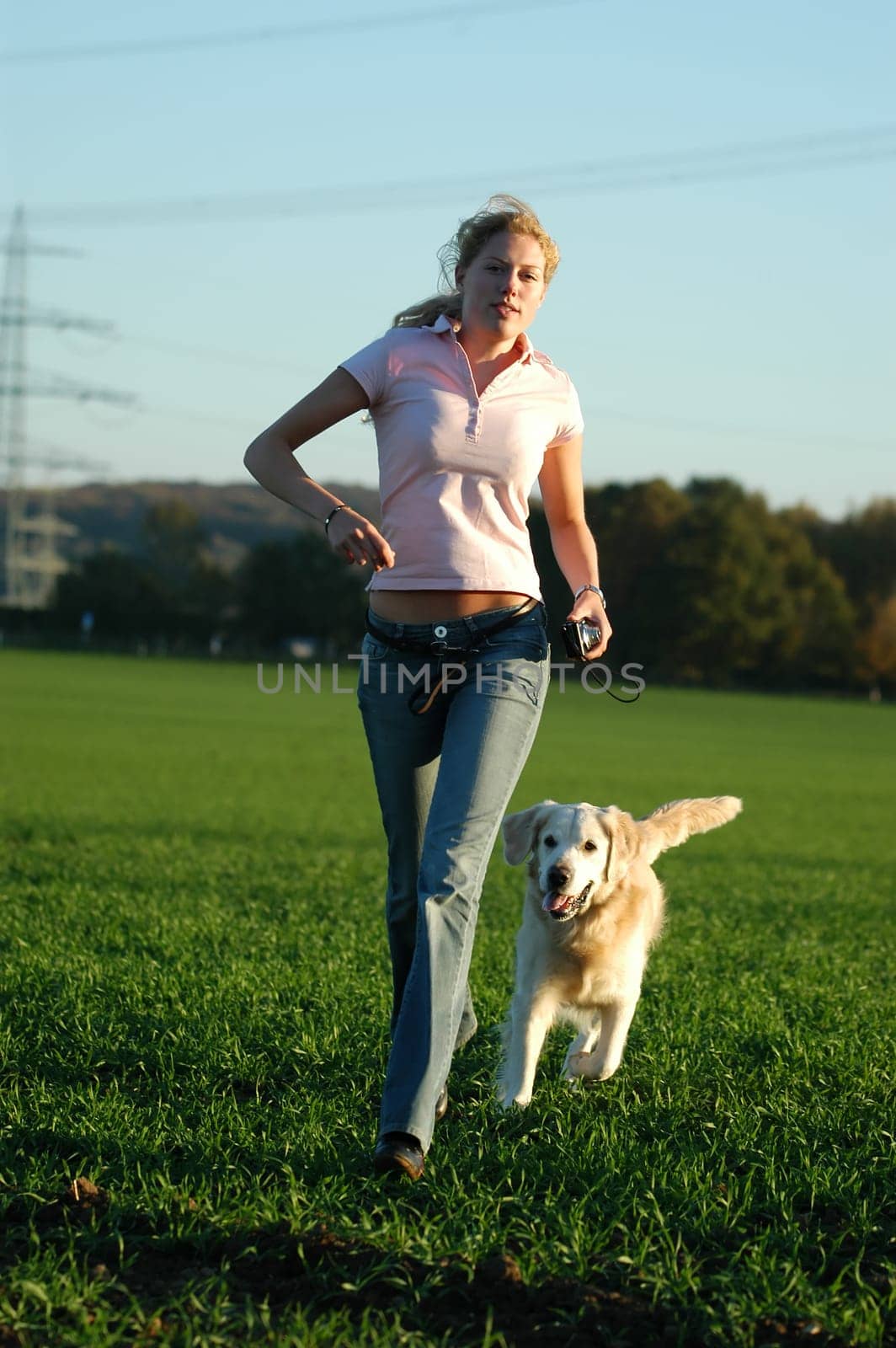 Young woman running with dog