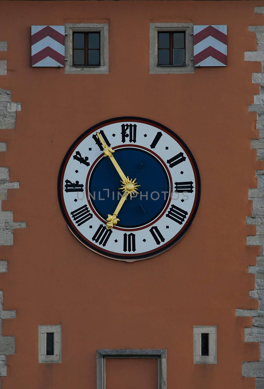 ... the historic clock on the bridge tower of the stone bridge in Regensburg...