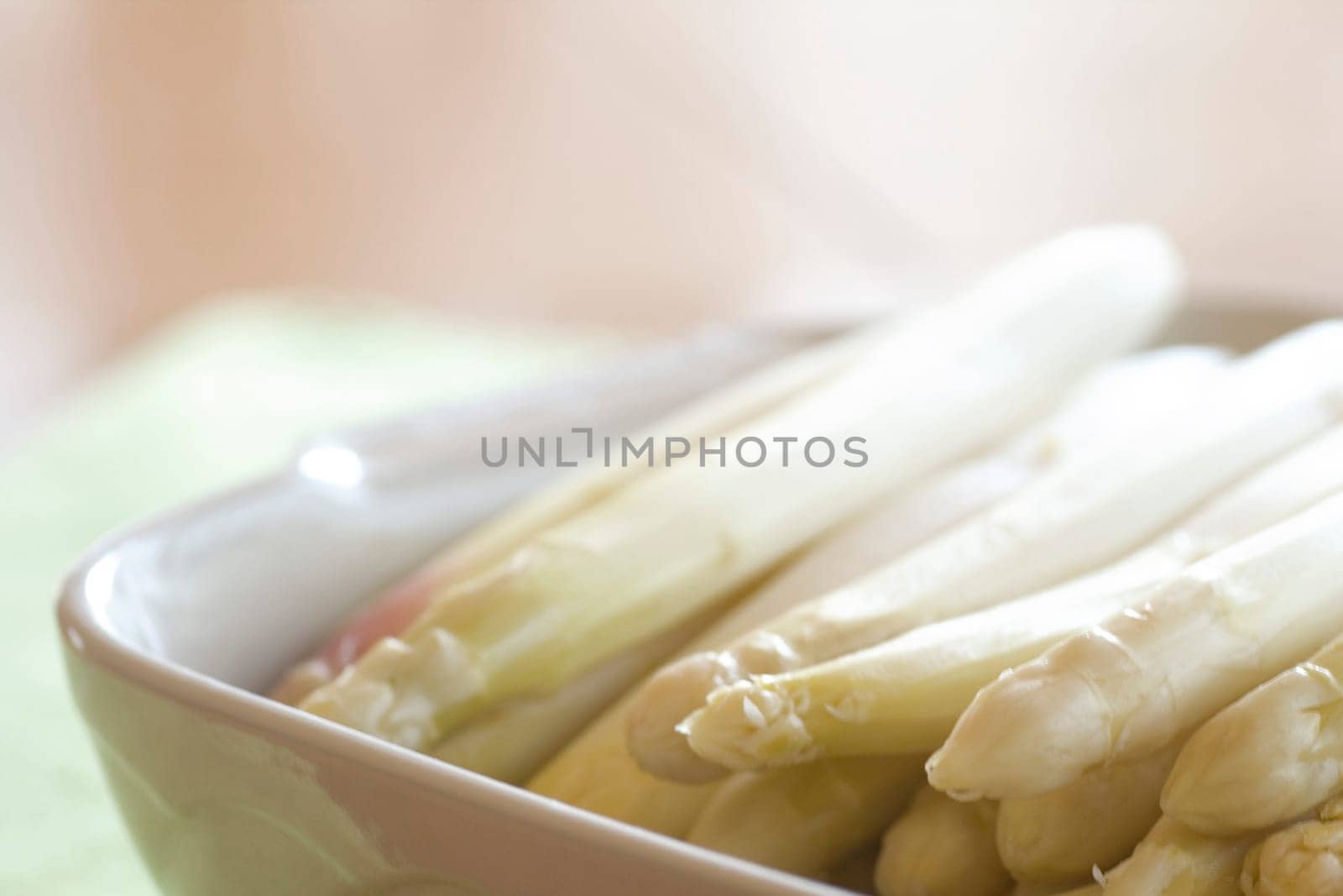 fresh asparagus in porcelain bowl