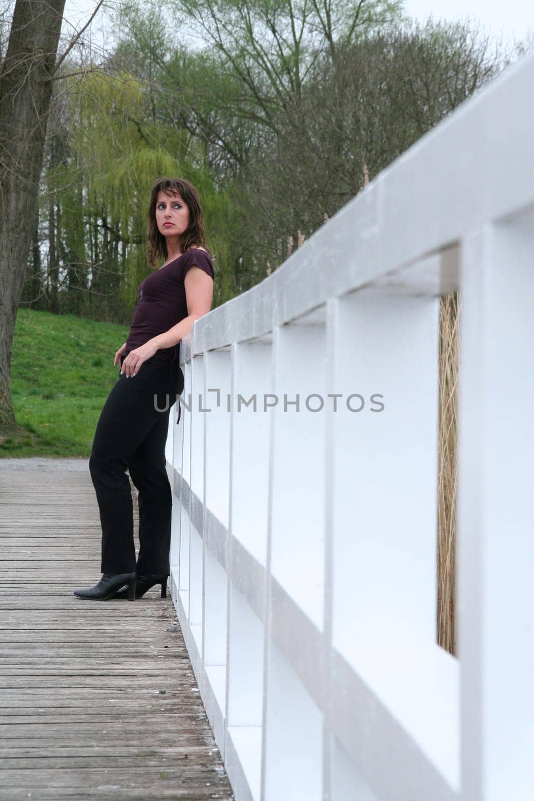 brunette woman leaning against railing
