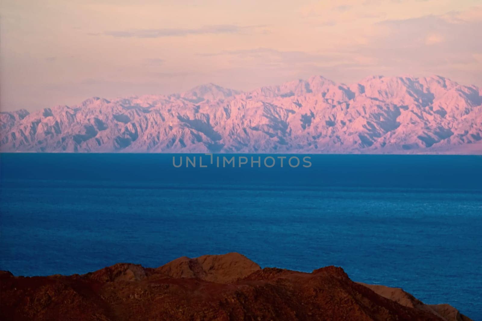 The Sinai greets the Saudi Arabian desert,what seems close is far away,the pink mountains in the background is the Arabian Desert and about 60 km away from me.... separated by the Gulf of Aqaba.....