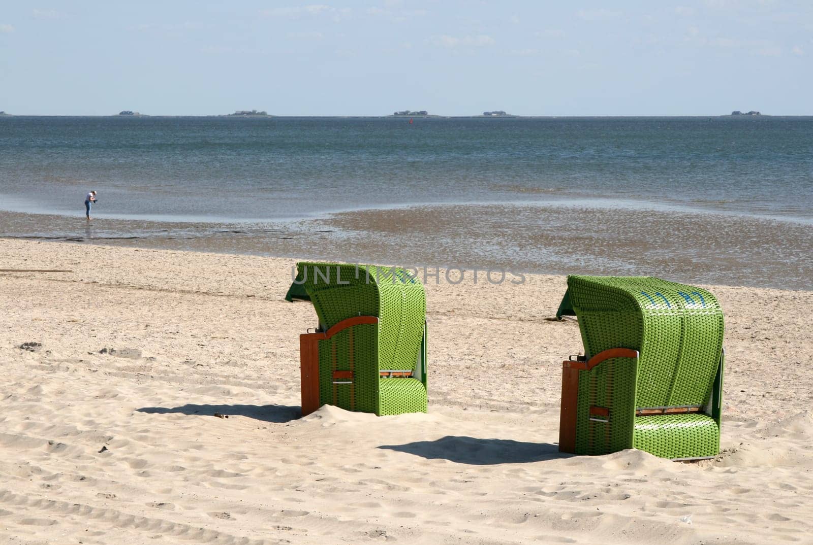 Two in green on the beach of Föhr,in the background the Halligen Langeneß.