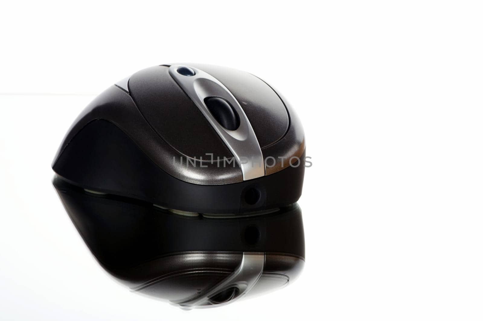 Wireless mouse cropped against a white background with reflection