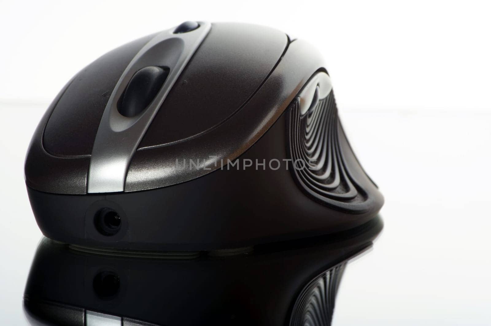 Wireless mouse cropped against a white background with reflection