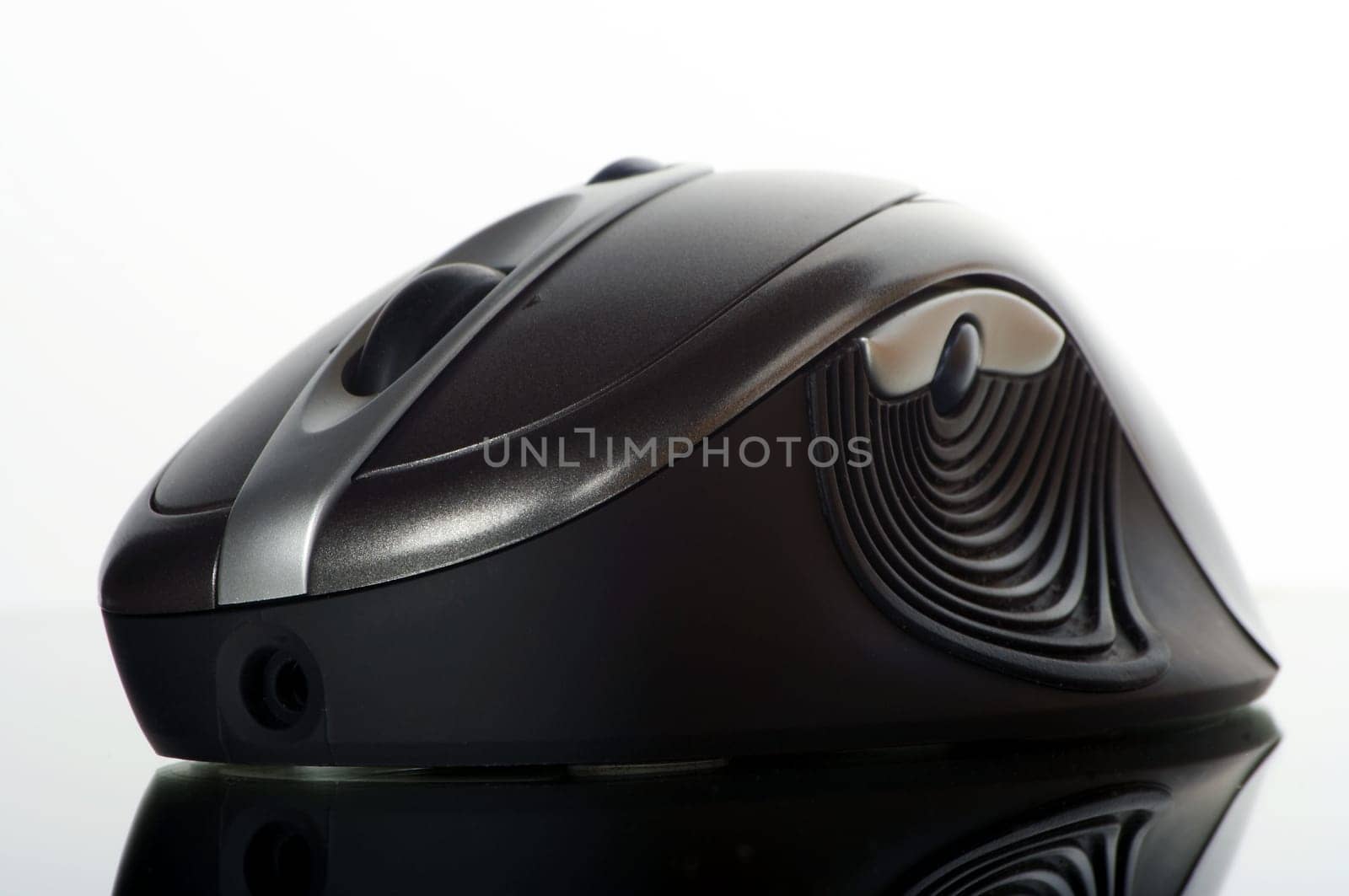 Wireless mouse cropped against a white background with reflection