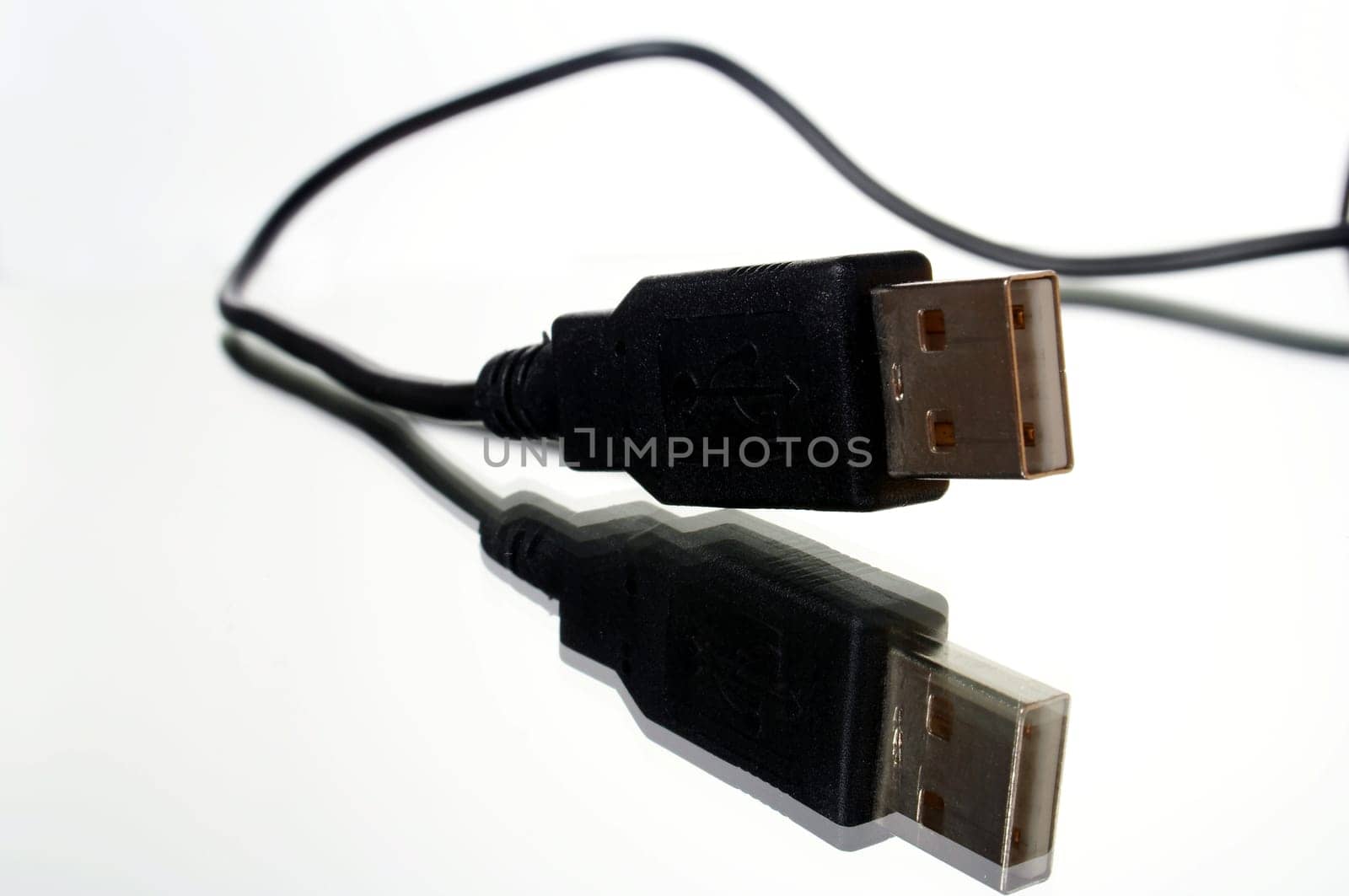 USB plug with cable exposed against white background with mirroring