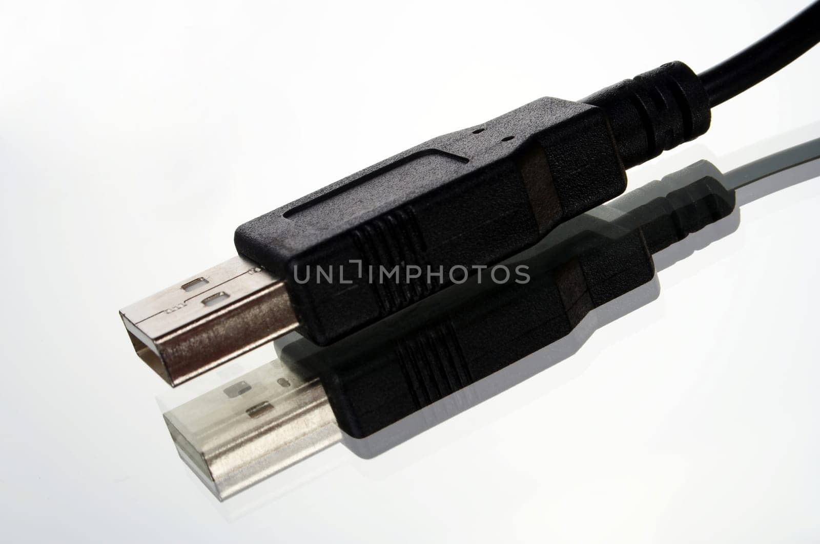 USB plug with cable exposed against white background with mirroring