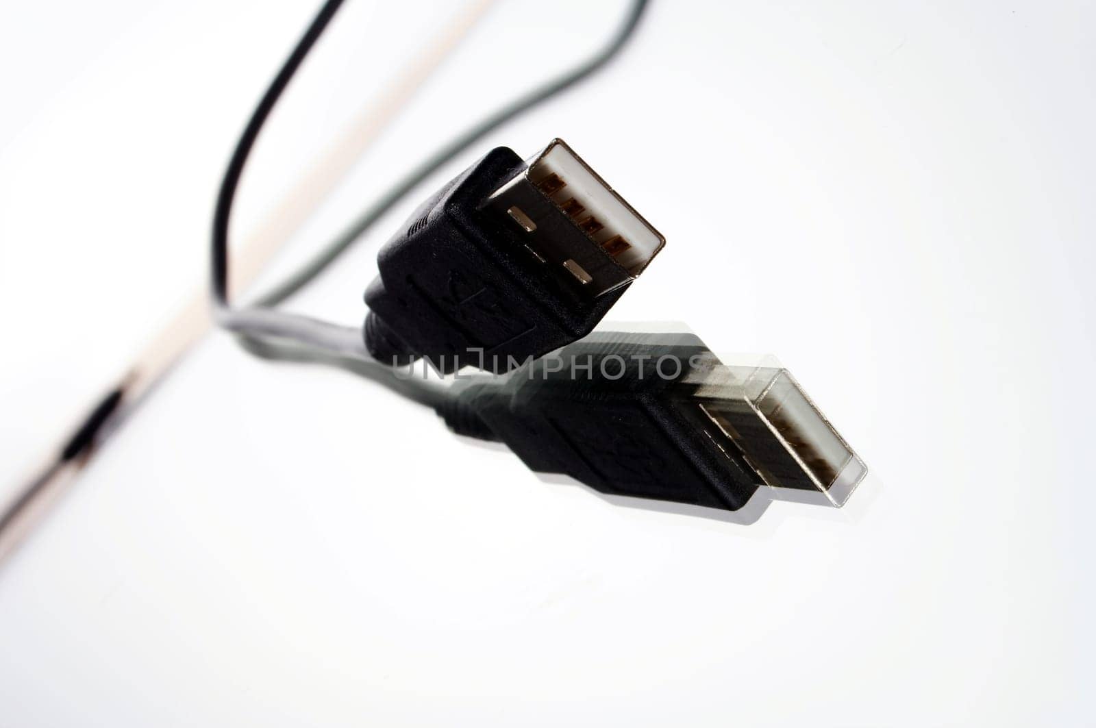 USB plug with cable exposed against white background with mirroring
