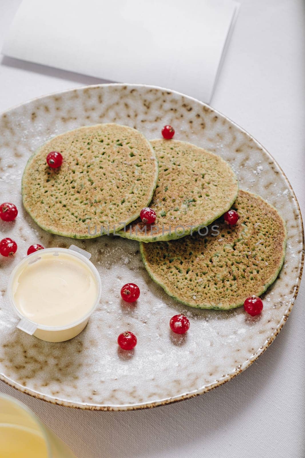 pancakes with berries and a glass of juice