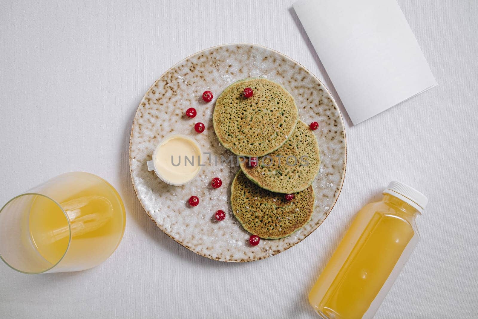 pancakes with berries and a glass of juice