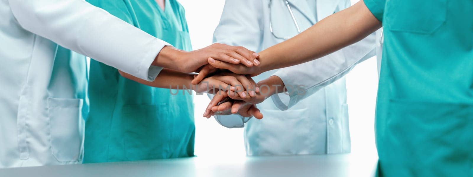 Group of medical staff doctor nurse and healthcare specialist profession coordinating synergy hand in hospital. Medical teamwork and healthcare cooperation in panoramic banner background. Neoteric