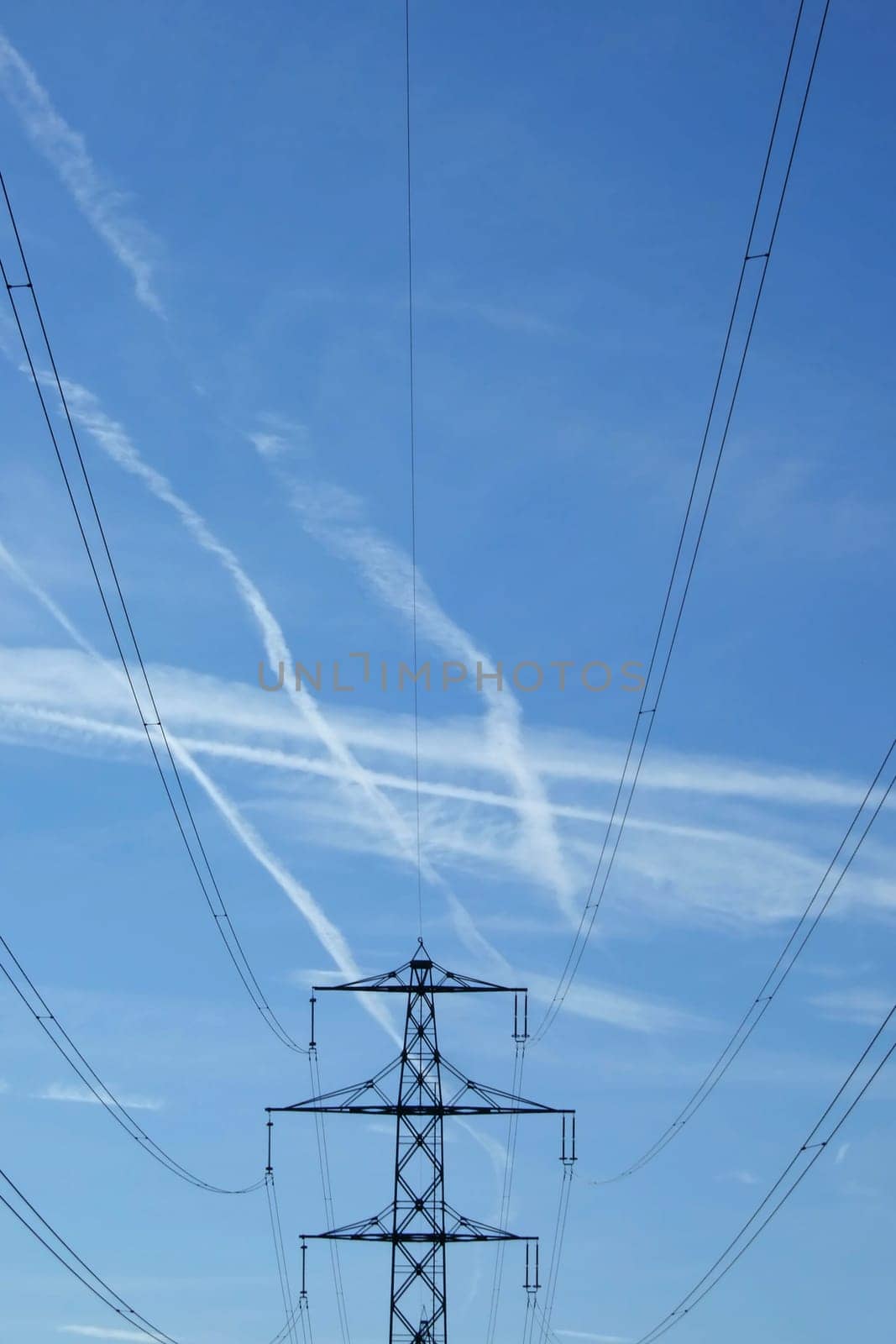 Electricity pylon in front of a blue sky