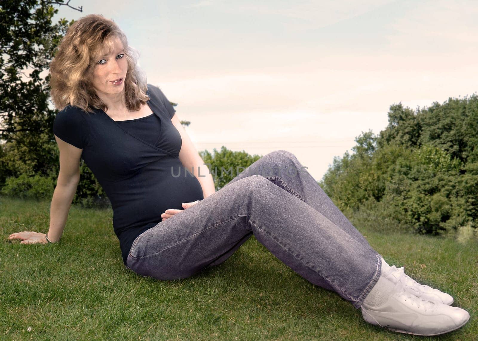 Pregnant woman on forest meadow