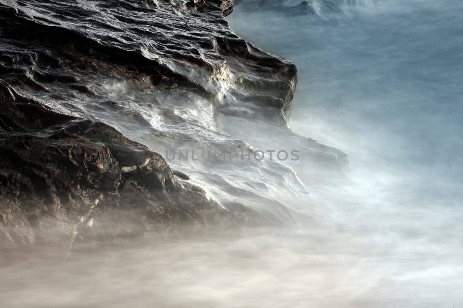 Waves break on the rock