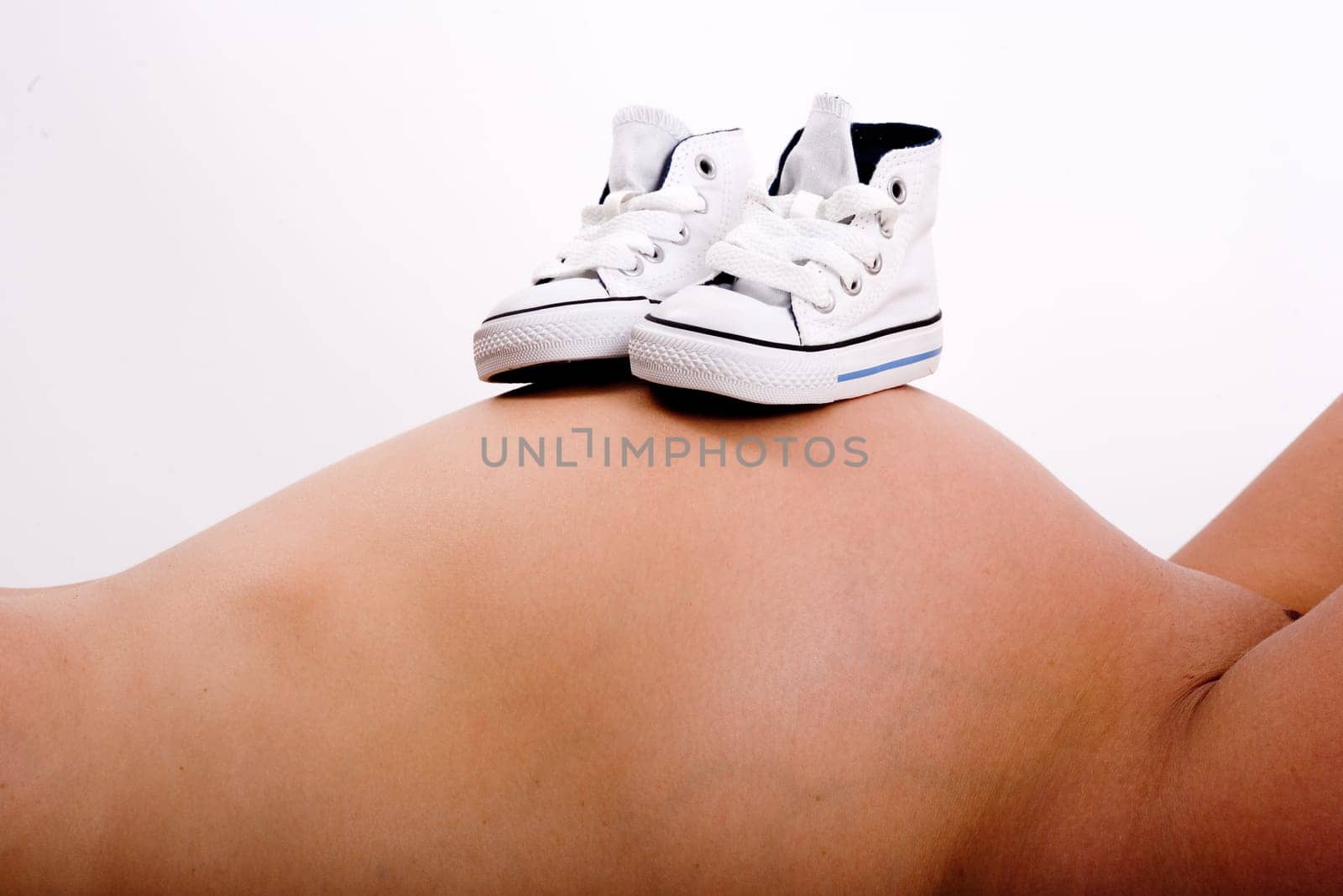 Baby shoes on mother's belly 2