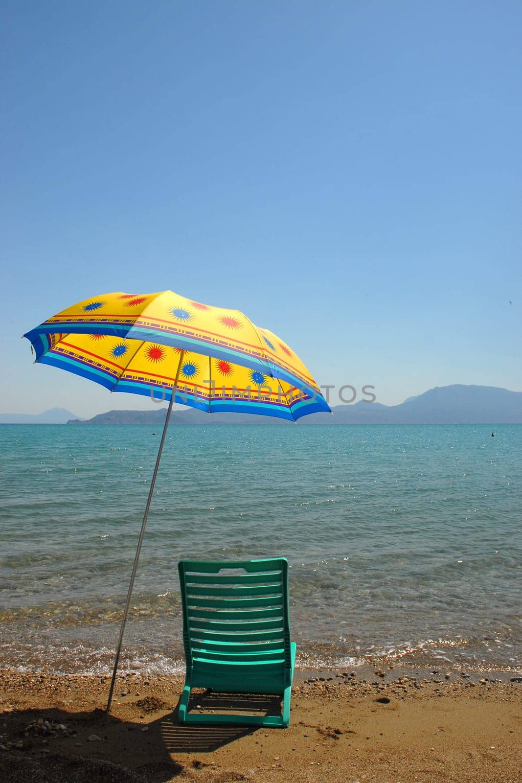 Umbrella and chair by the sea