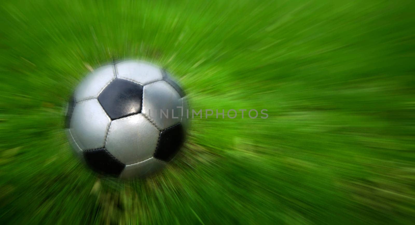 Football on a green grass