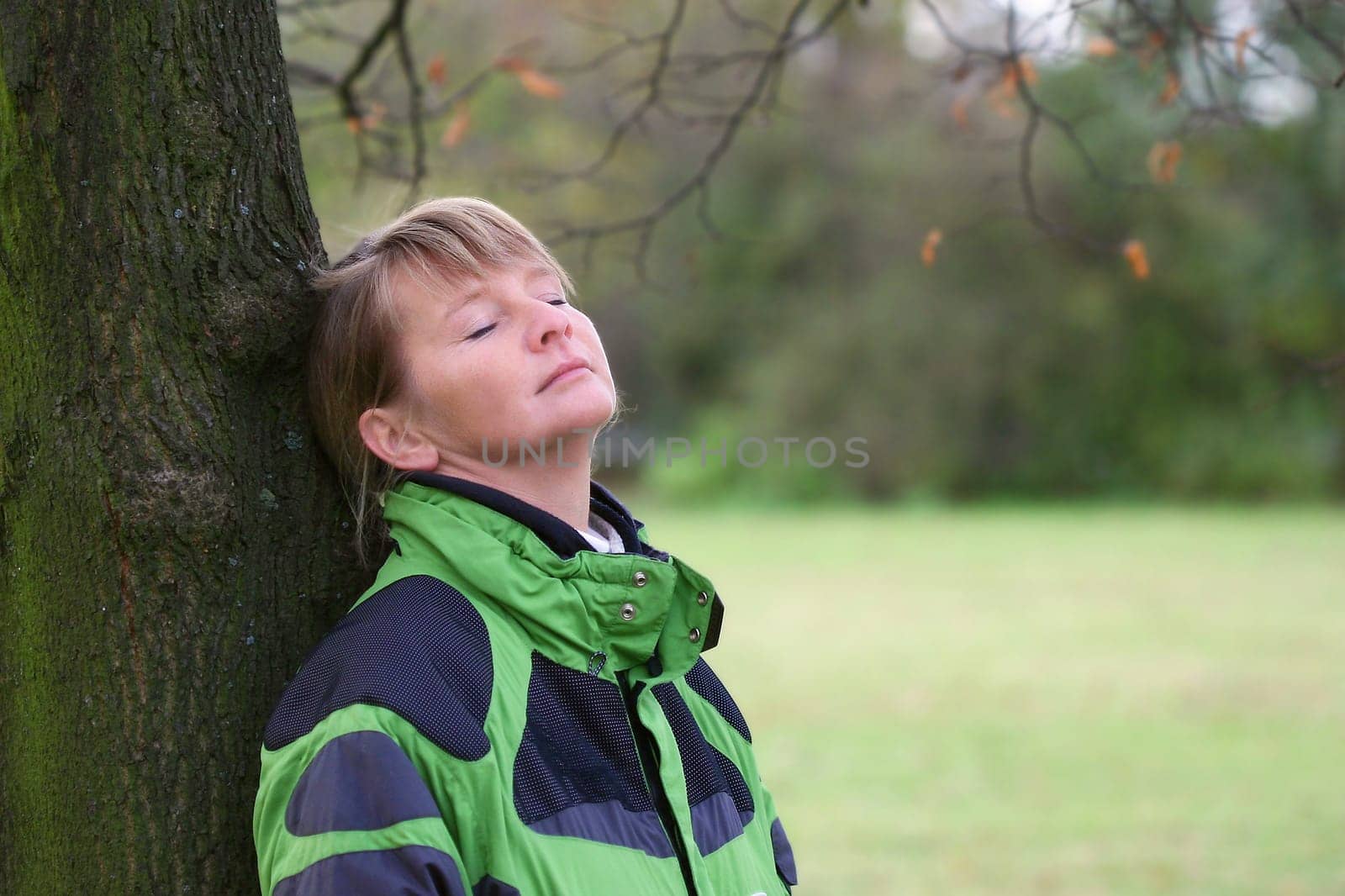 Woman under a tree in autumn