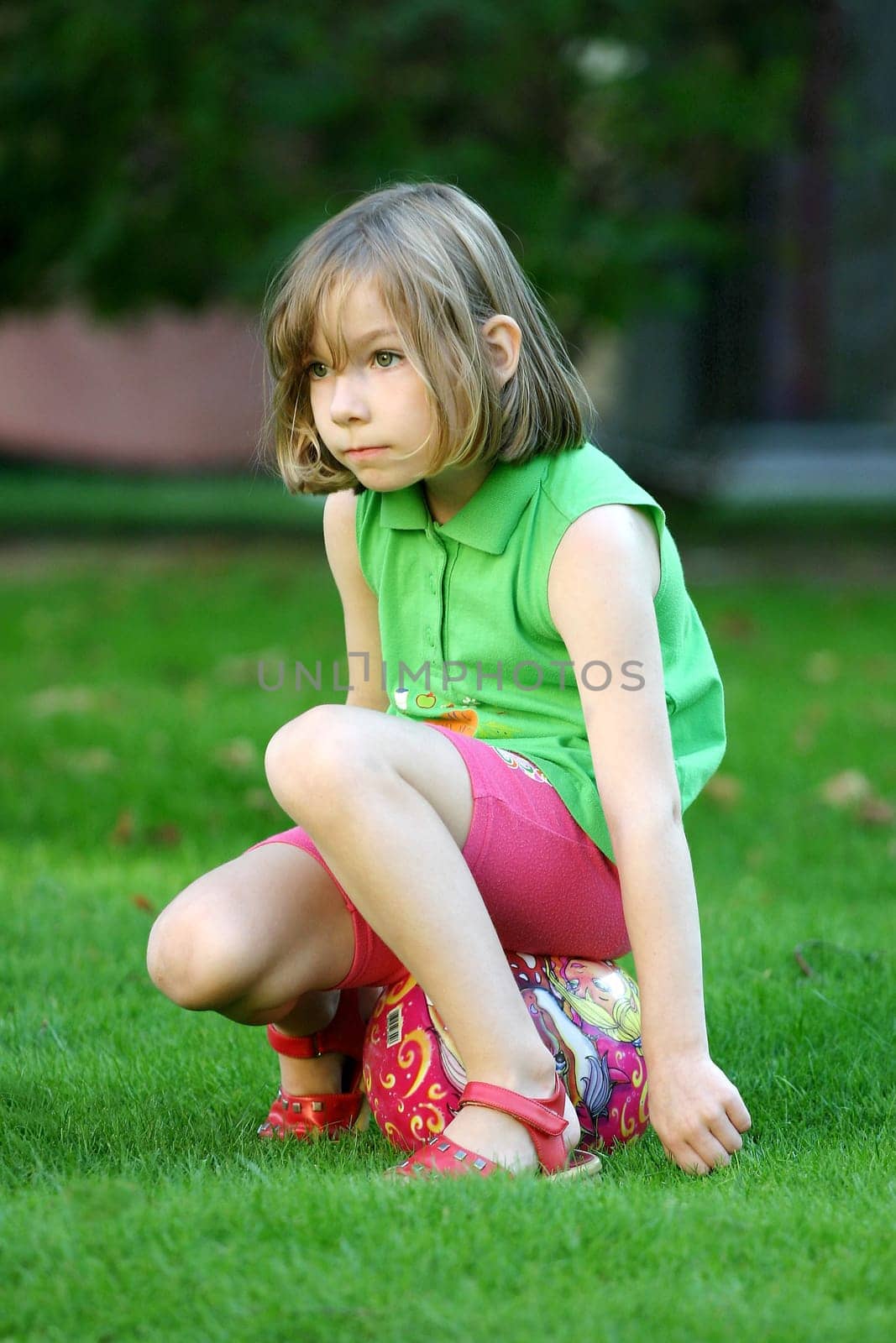 Child sitting on a ball