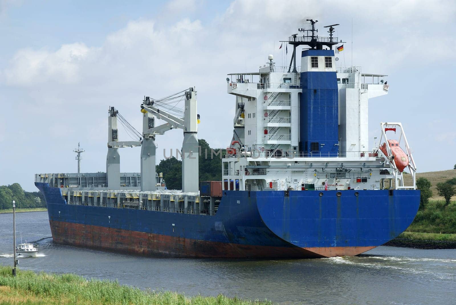 A 188m long colossus slowly pushes its way through the Kiel Canal