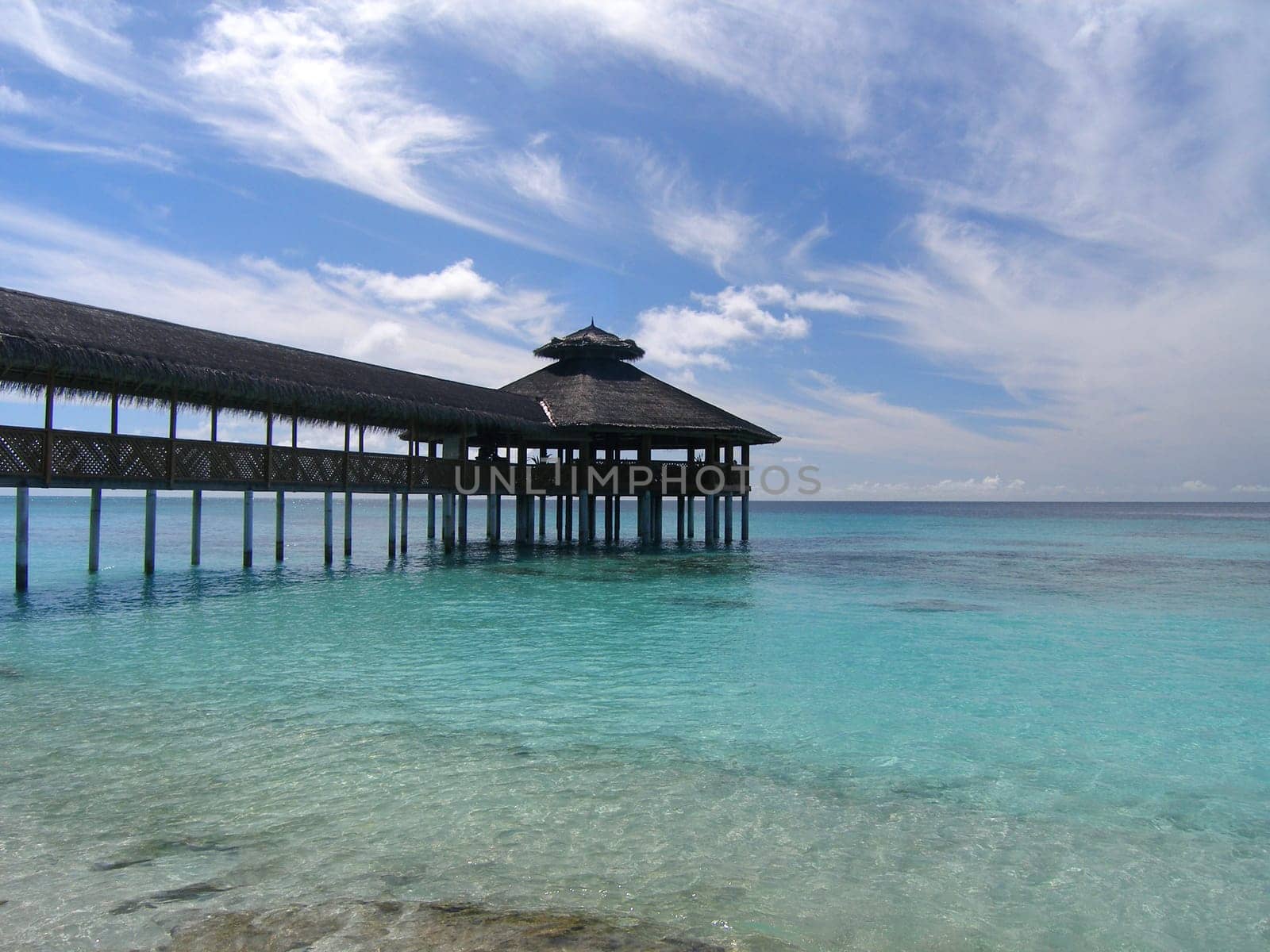 A restaurant above the waves of the Maldives.