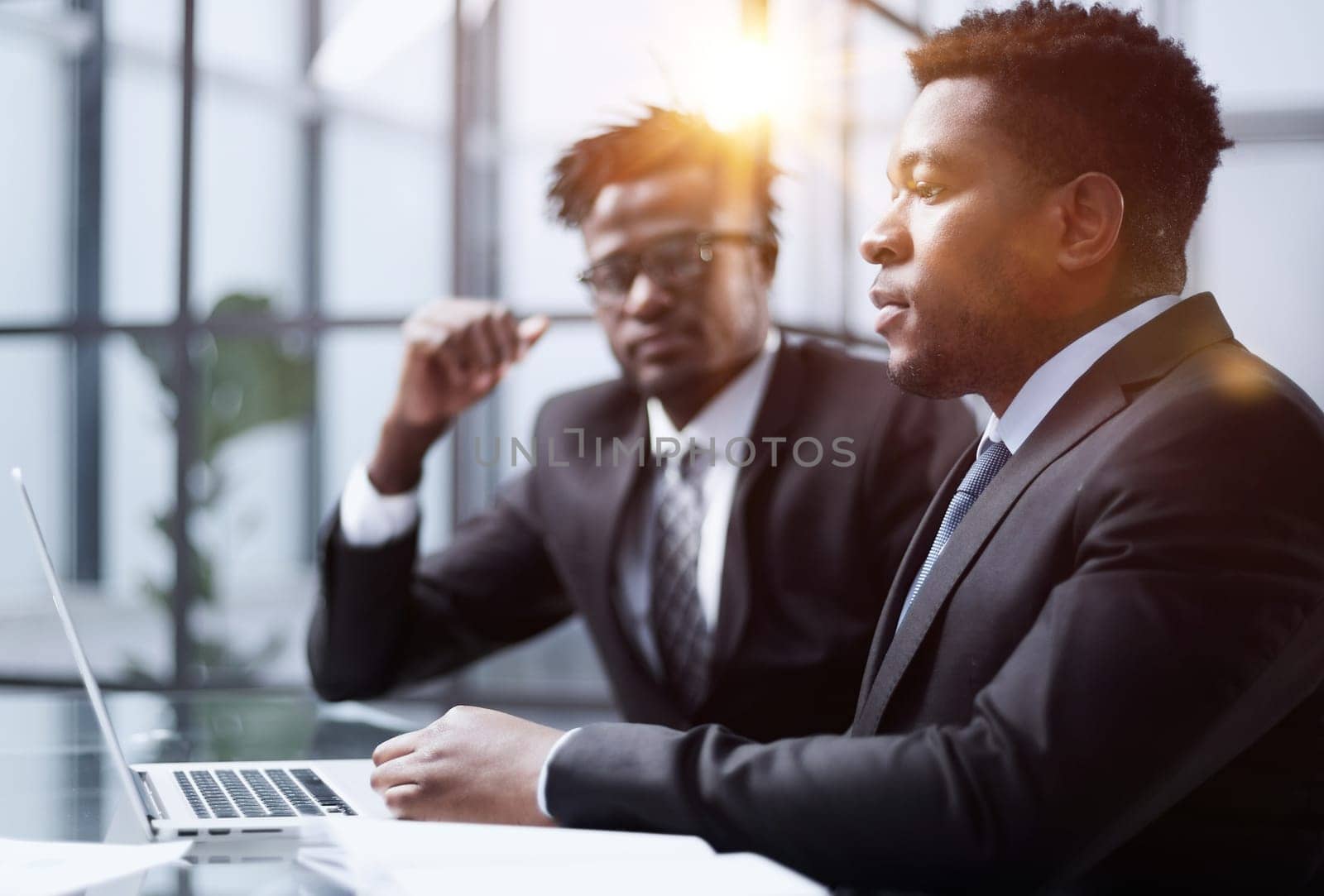 African american boss negotiating discussing contract details with company corporate client.