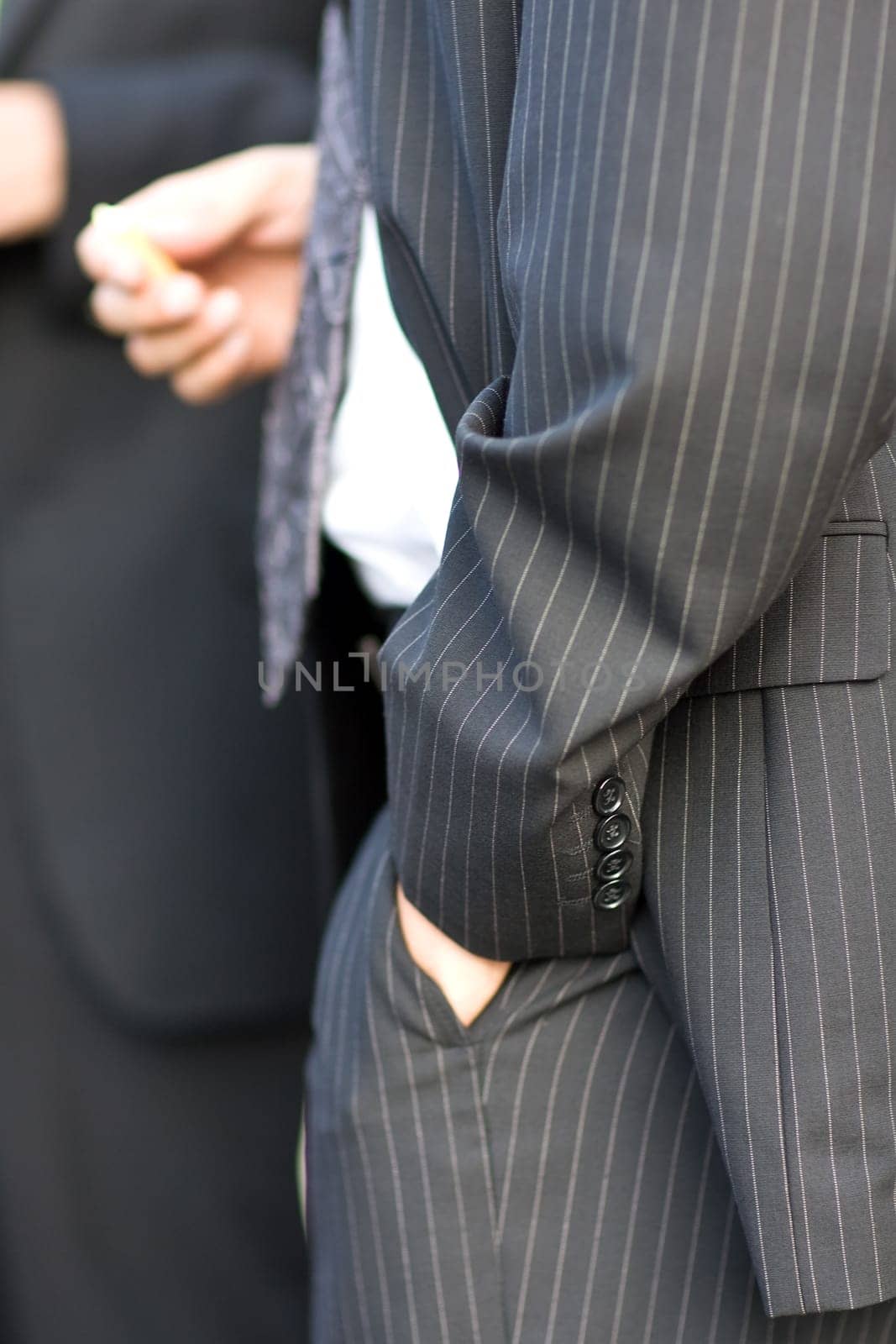 Hand casually in trouser pocket
