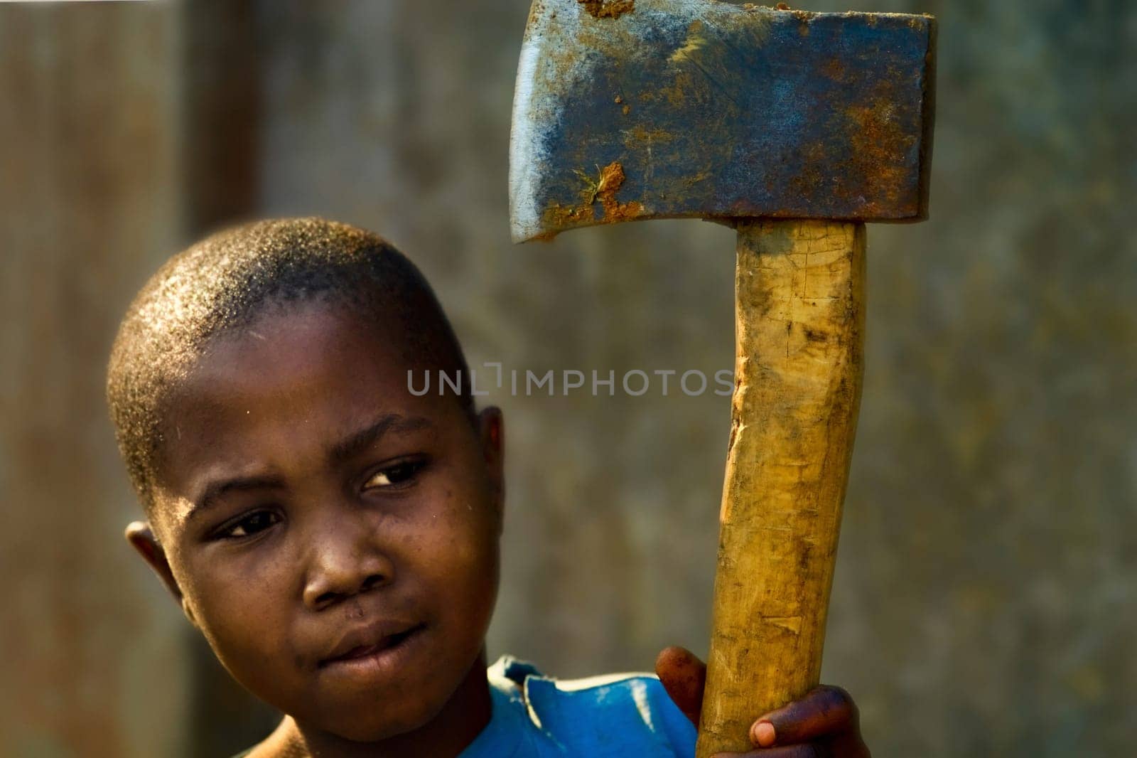 ... with which he chopped wood,he is very proud of it,his daily work: cutting wood for the stove,for the fire with which the daily meal is cooked...