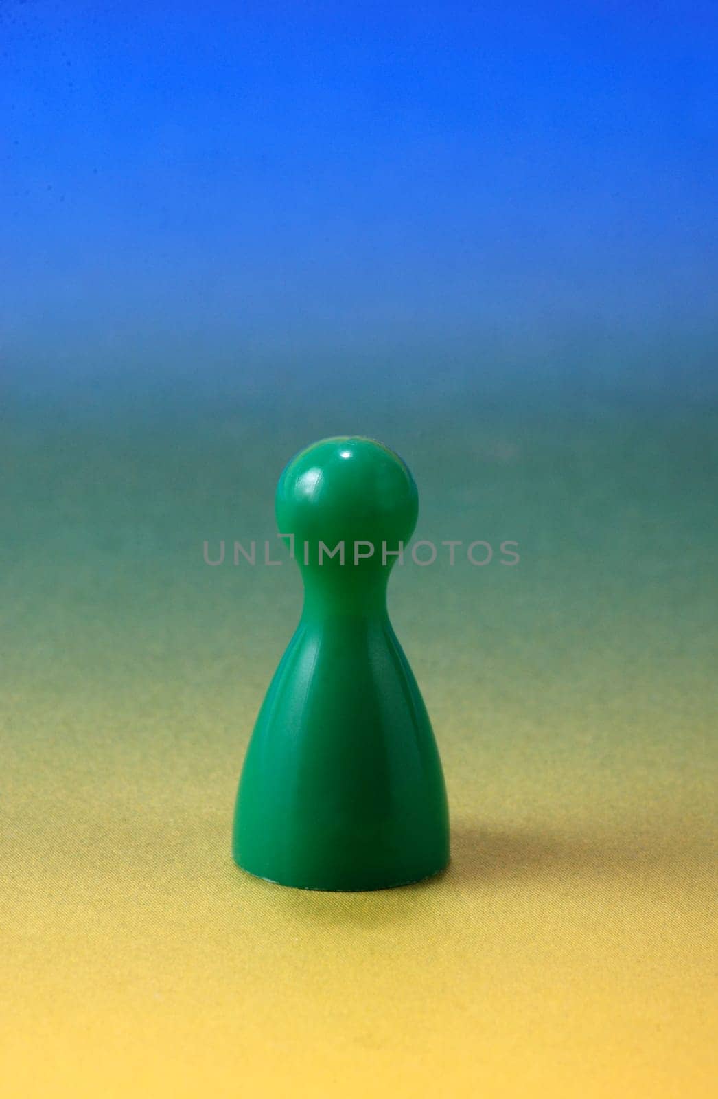 Green pawn in front of color gradient