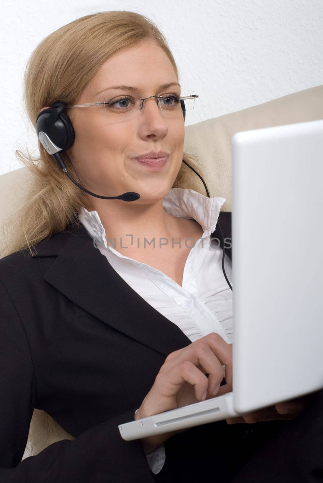 Young woman with headset and laptop