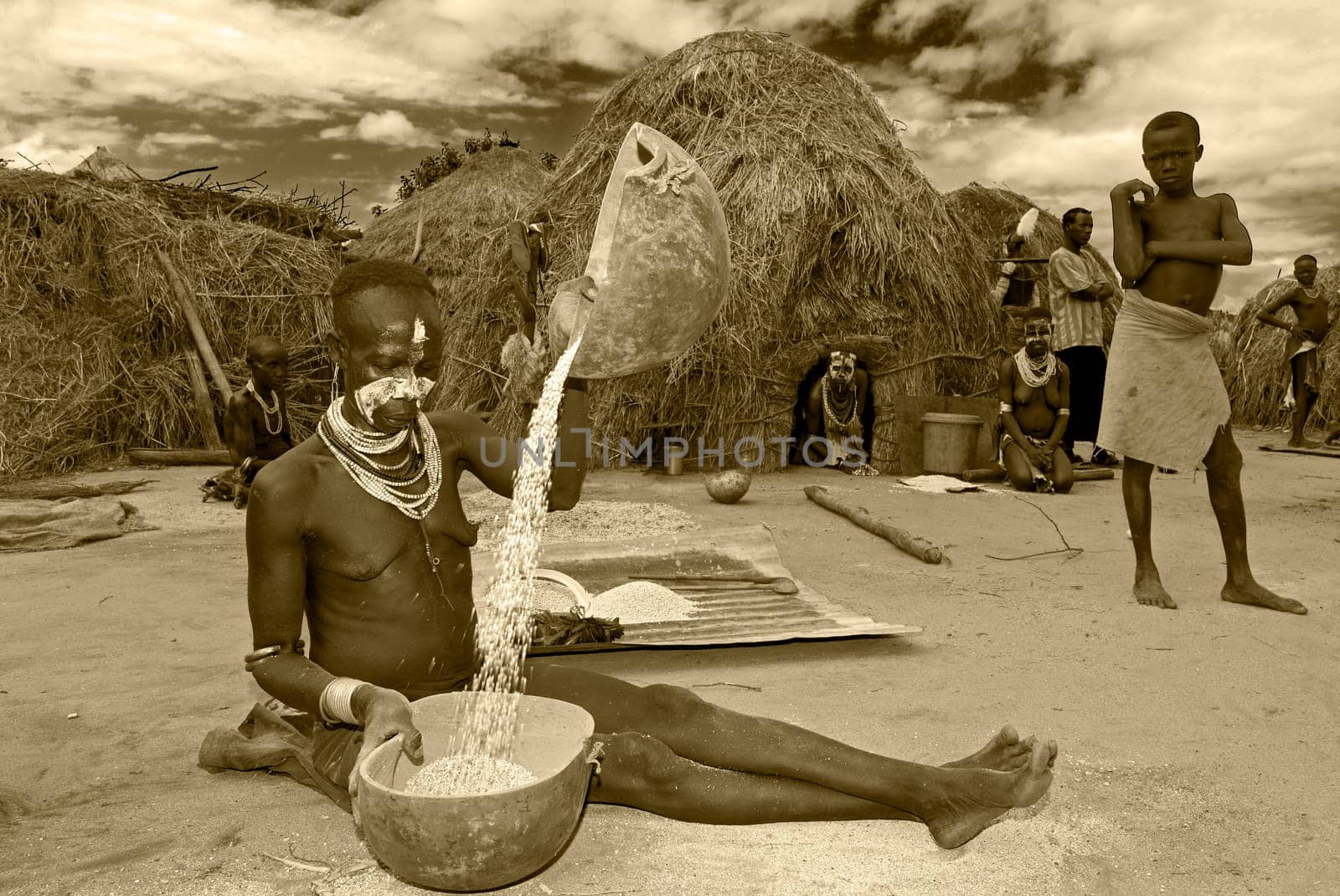 Karo village in southern Ethiopia Woman separating the grain from the chaff.