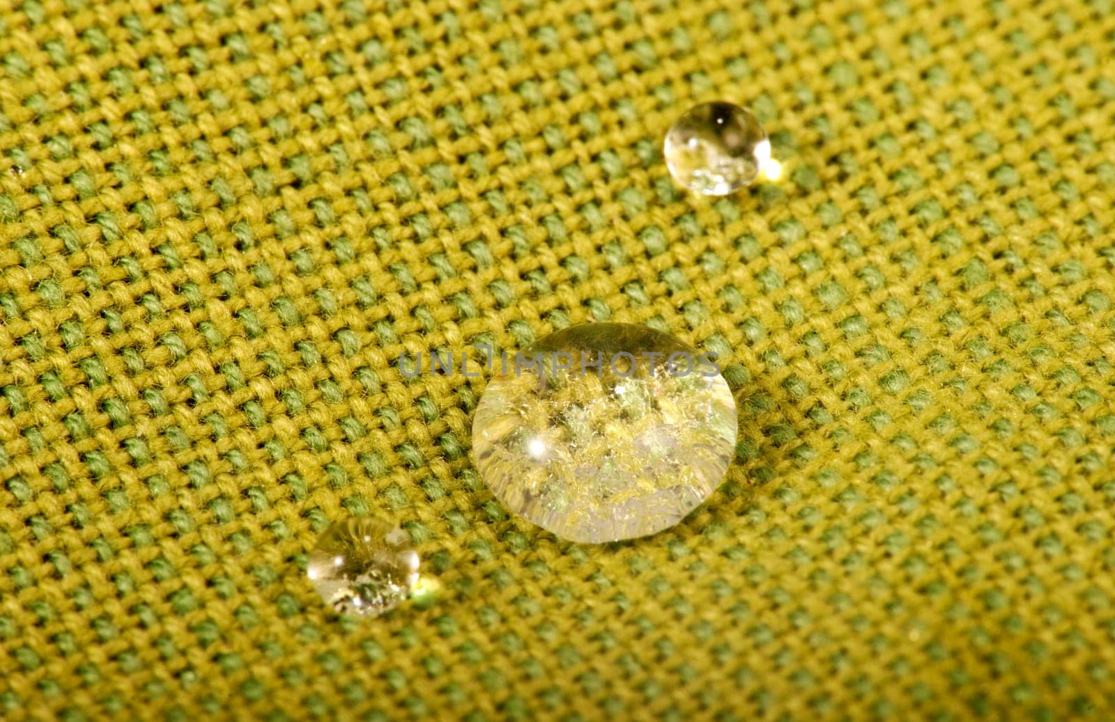 Water drops on green fabric