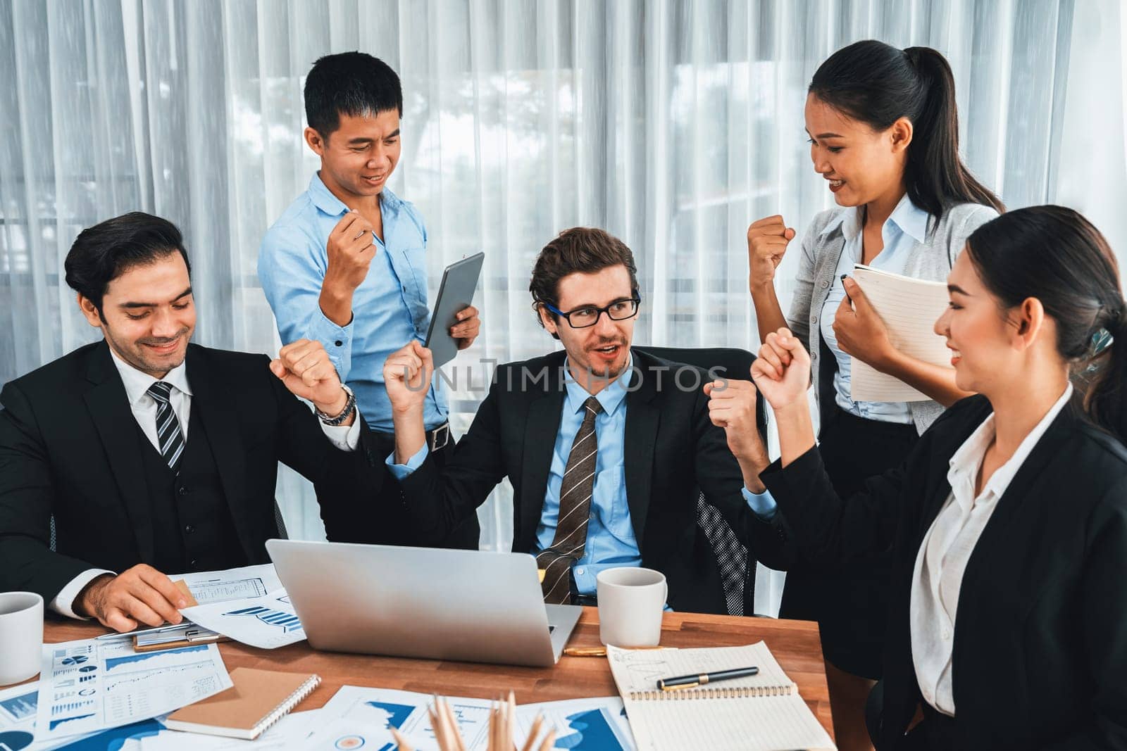 Diverse race office worker celebrate after made progress. Meticulous by biancoblue