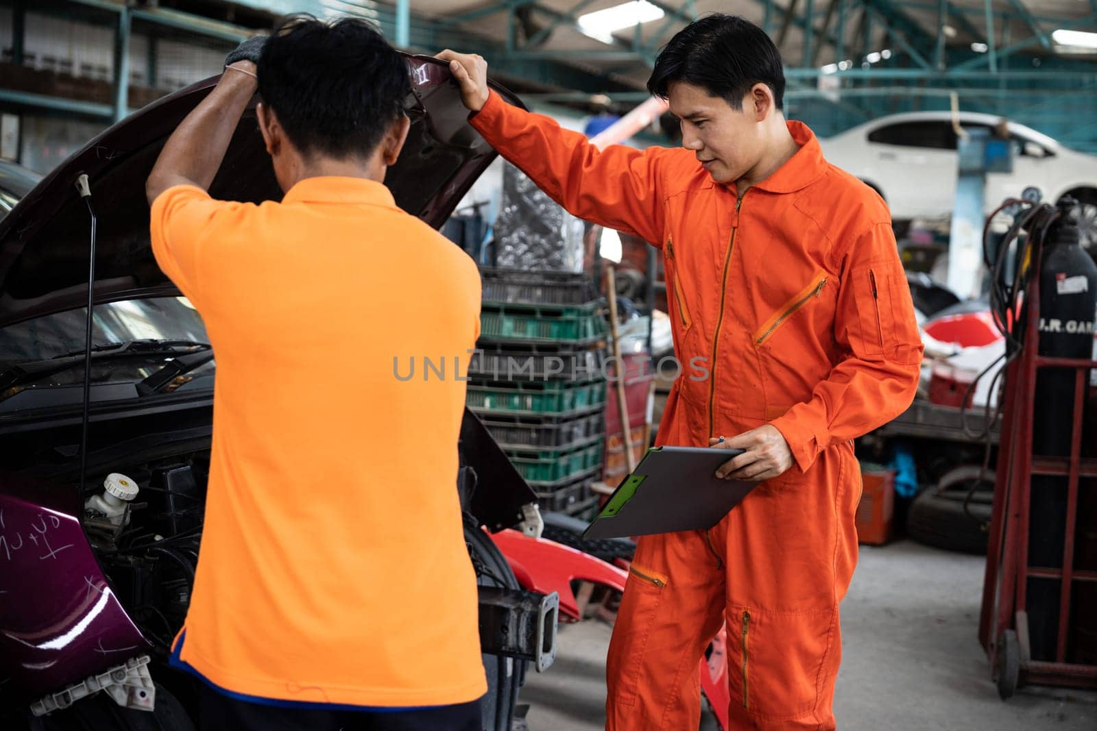 Automotive service mechanic inspect and diagnose car engine issue, repairing and fixing problem in garage workshop. Technician car care maintenance working on internal components of vehicle. Oxus