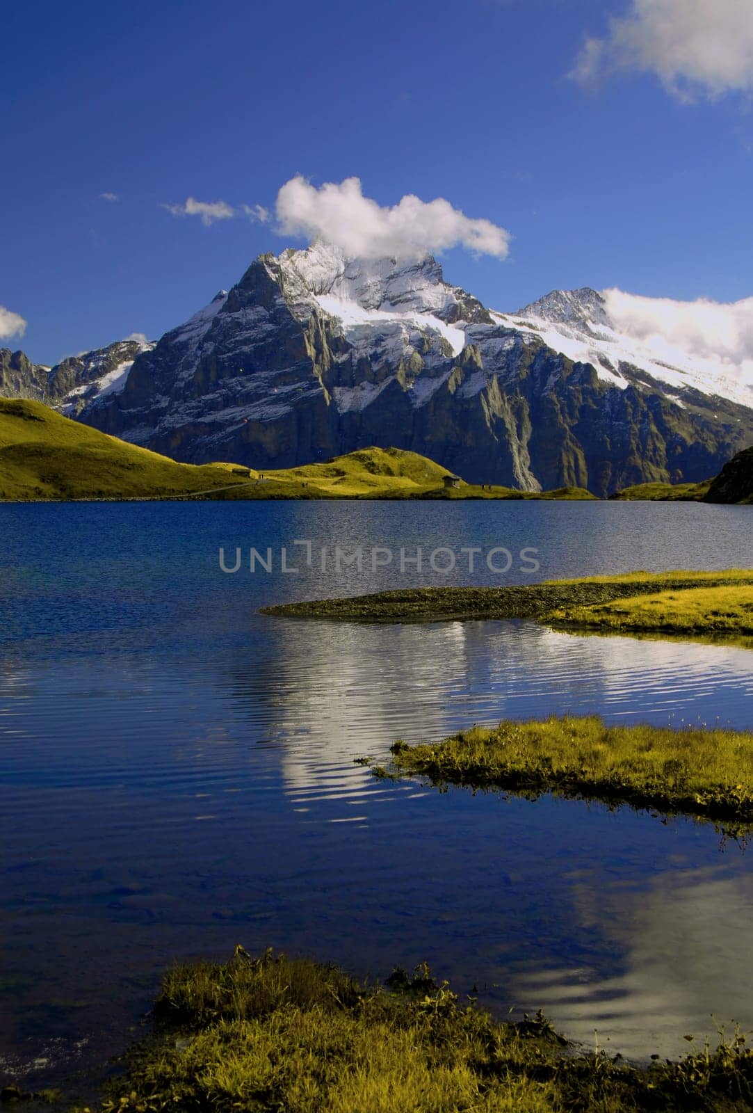 The Bachalpsee is a picturesque small mountain lake on the ridge above Grindelwald in the Bernese Oberland. It is located at 2,265 m above sea level and consists of two parts,separated by a small natural dam,with the lower part being 6 metres lower. By se