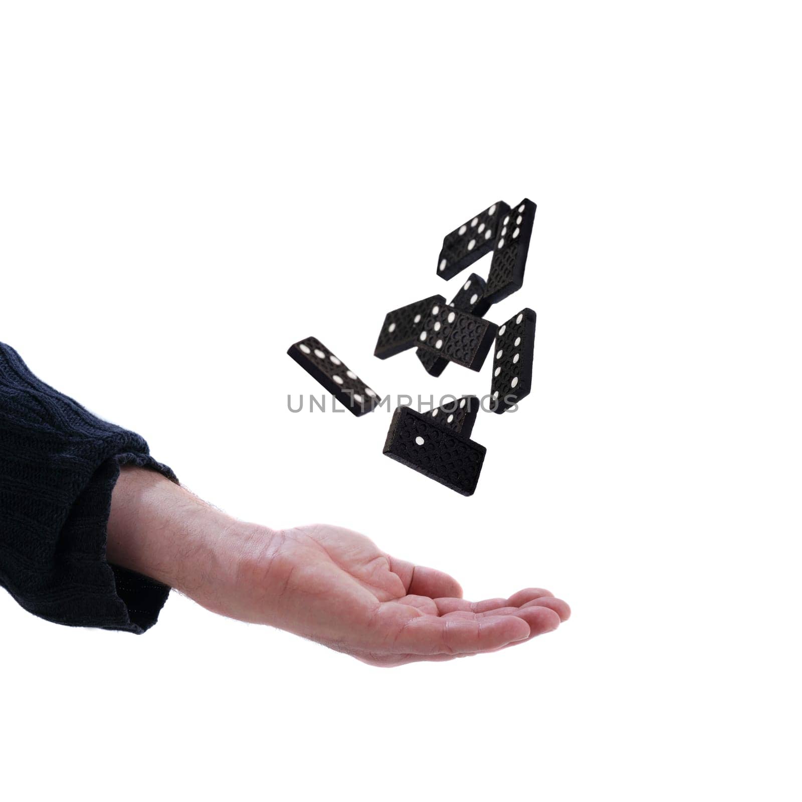 Hand throws up dominoes