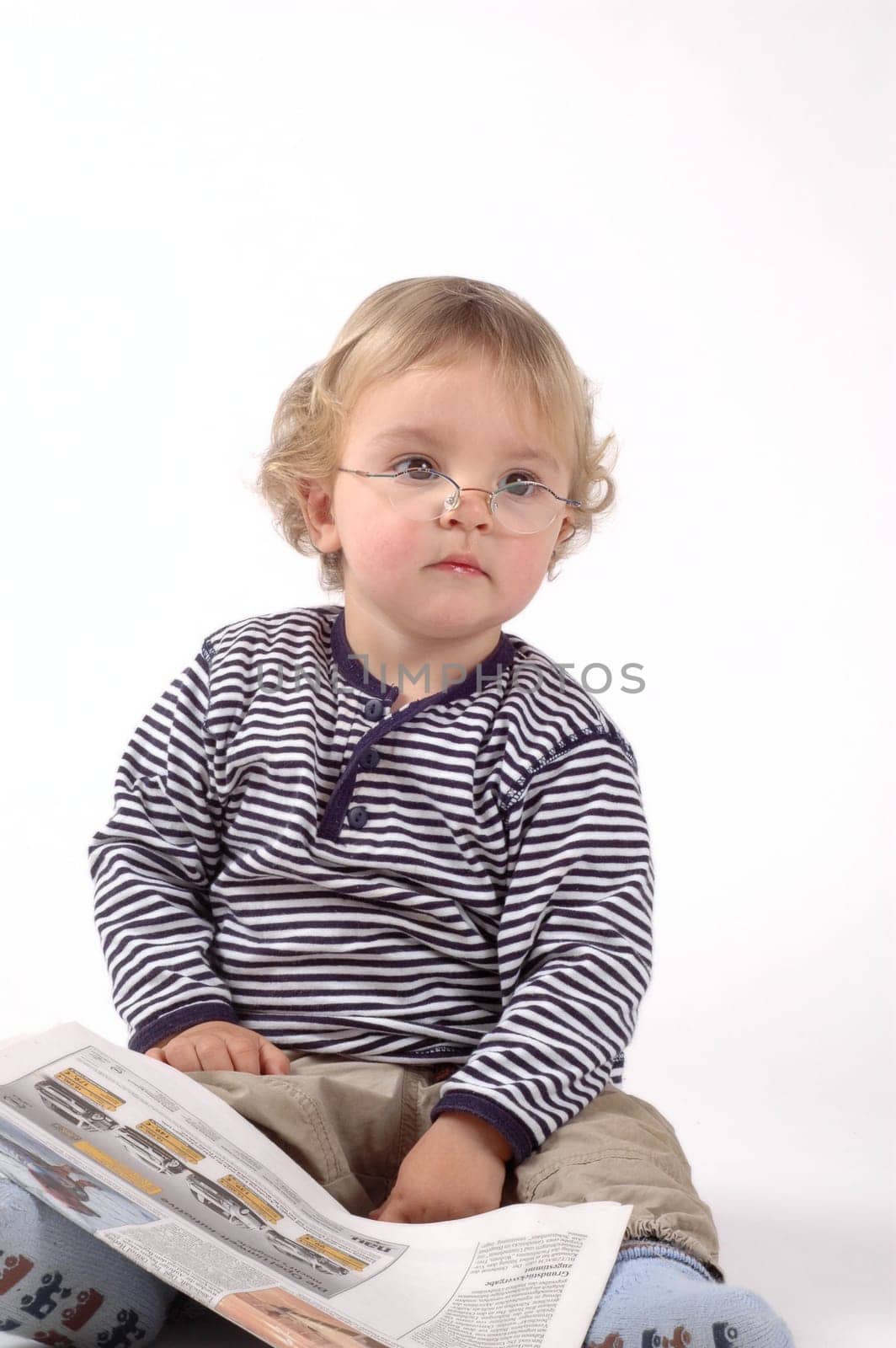 Child with glasses and newspaper
