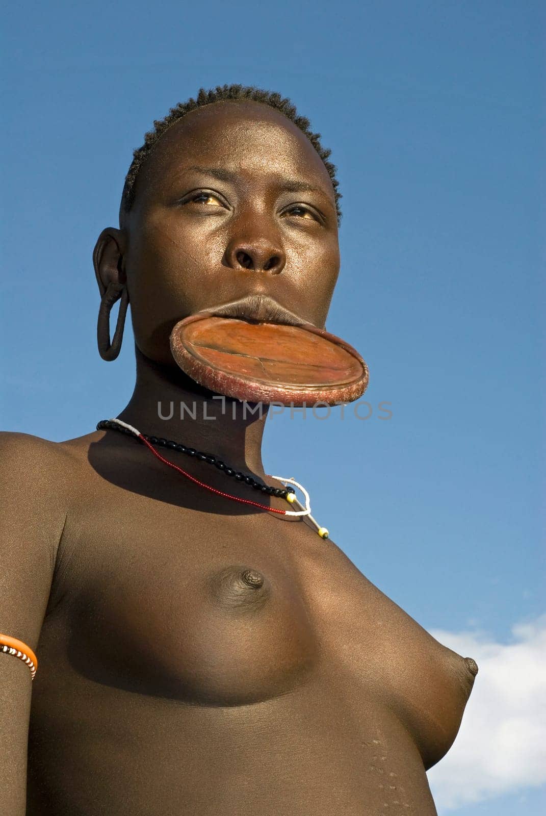 Young girl of the Mursi tribe with the typical clay lip plates,southern Ethiopia,near the Sudanese border.