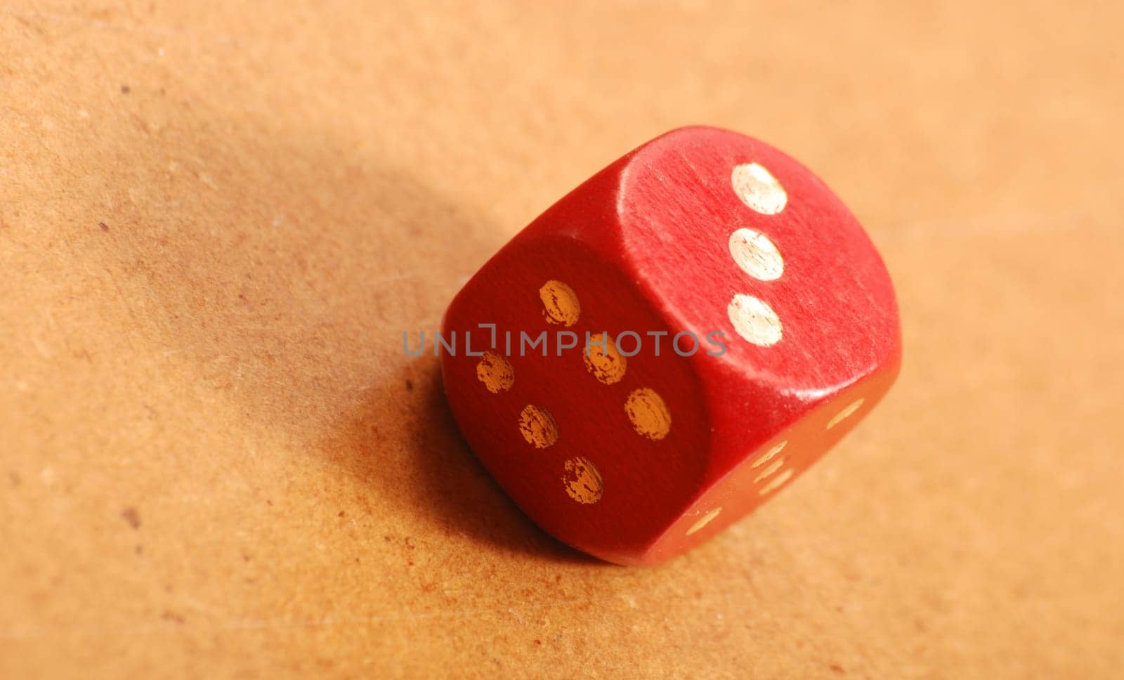 Red cube on wooden table