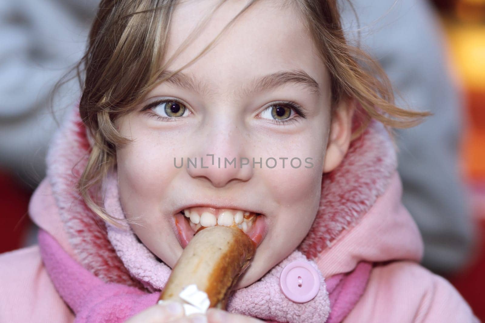 Girl nibbling on a bratwurst