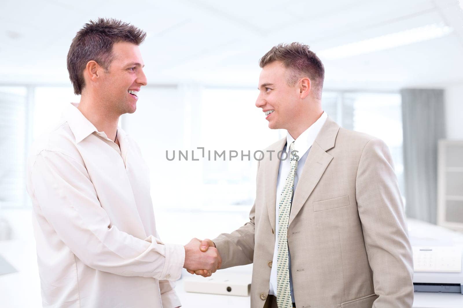 Businessmen shaking hands at office