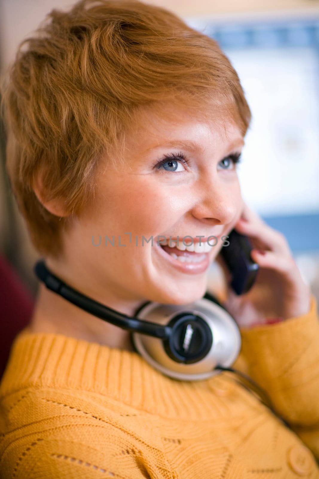 Woman on cell phone wearing headphones