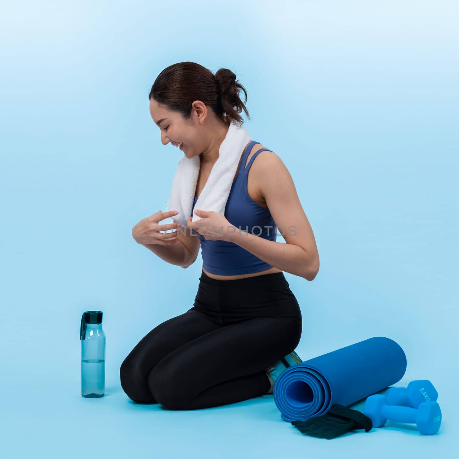 Athletic and sporty asian woman resting after intensive cardio workout training. Healthy exercising and fit body care lifestyle pursuit in studio shot isolated background. Vigorous