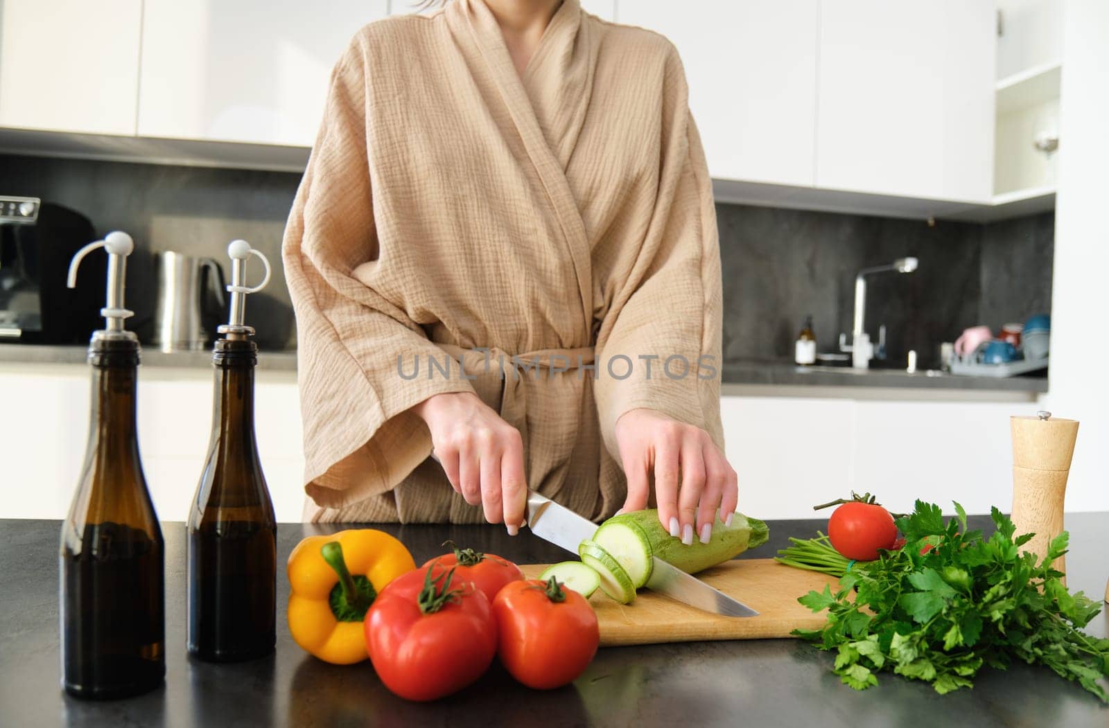 Close up portrait of female hands, woman wearing robe, cutting vegetables on chopping board, cooking vegan dinner, vegetarian meal for family, standing in kitchen by Benzoix